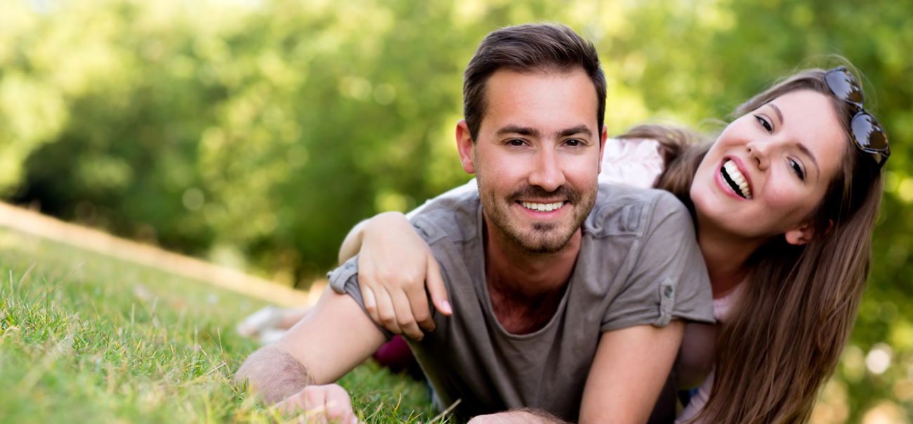 Young man and woman smiling after wisdom tooth extractions in Tysons Corner