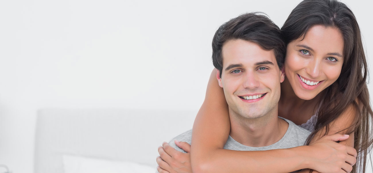 Man and woman sharing healthy smiles after visiting Tysons Corner Dentists