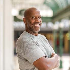 Man with dental implants in Vienna smiles confidently